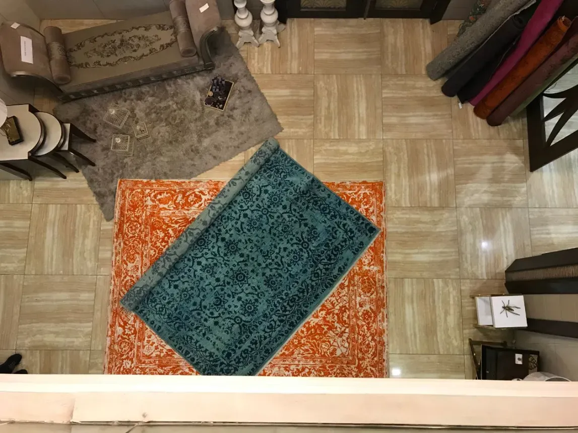 Area rugs laid out and staged on the facility floor