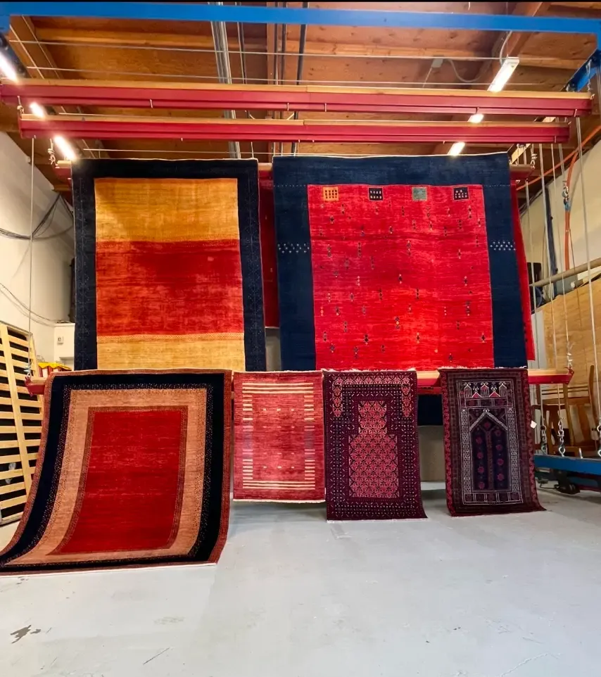 Oriental rugs hanging to dry under controlled conditions